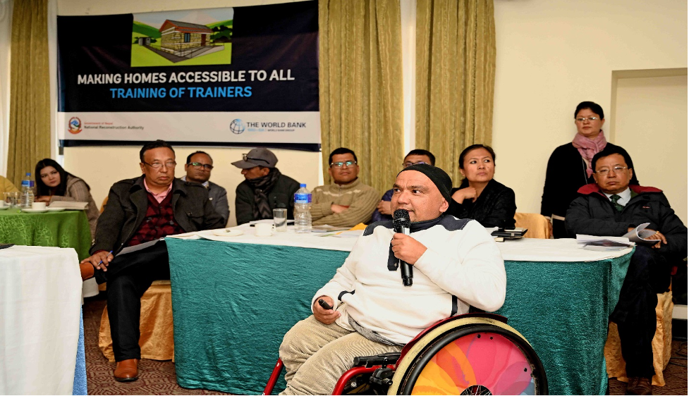 Deepak Khatri Chhetri on a wheelchair addressing a group of people